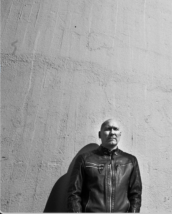 Janski against a concrete wall, black and white